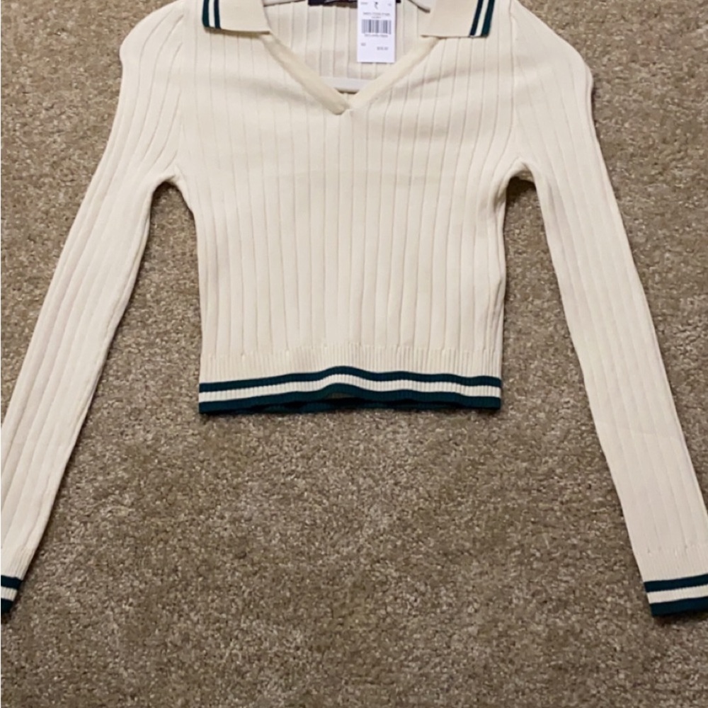 White top with green stripes